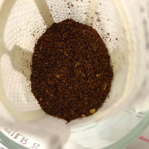 Freshly ground coffee inside a Beanz Drip disposable drip bag, highlighting quality and freshness.