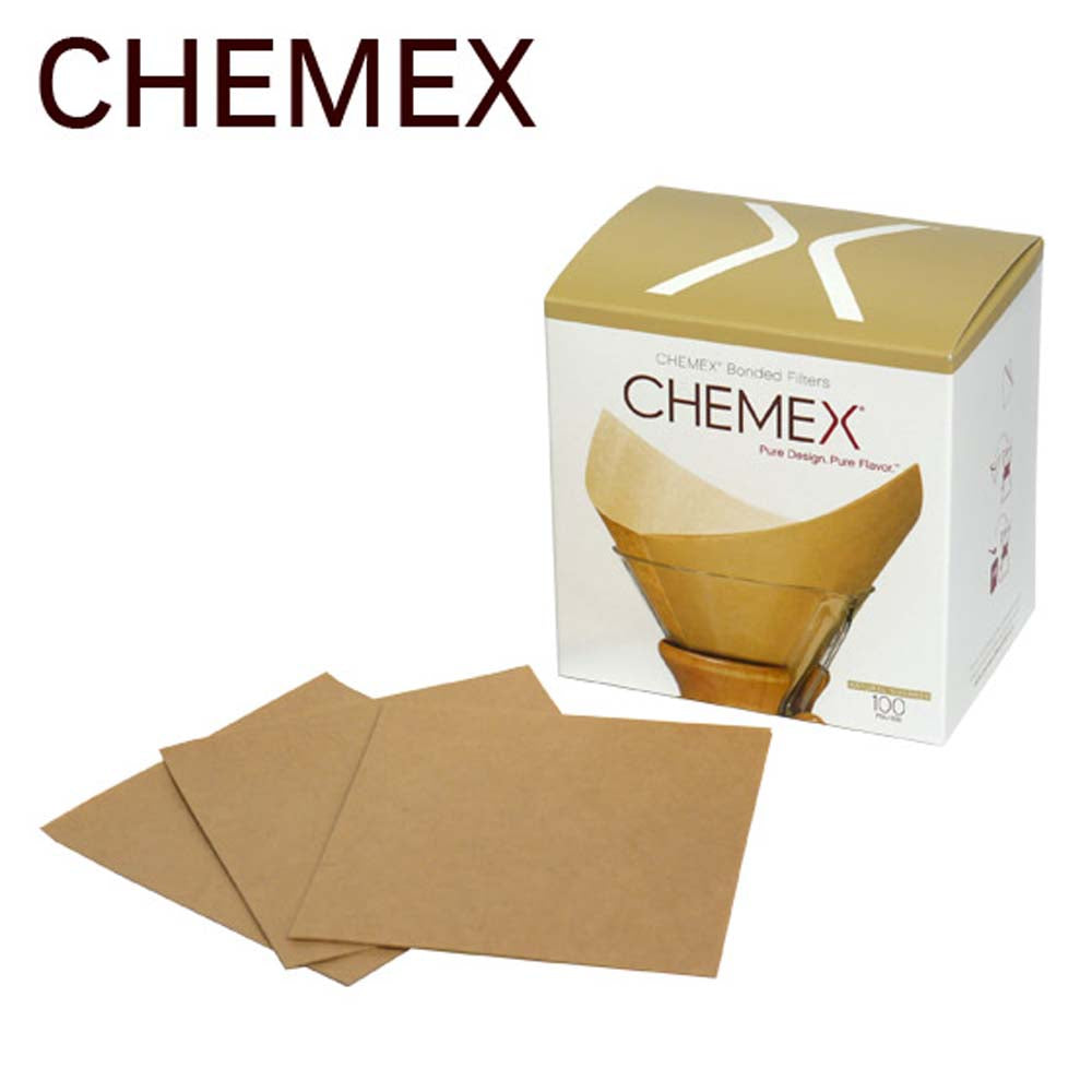 One box of Chemex Pre-folded Square Filters—100 pack—is natural in color and has several paper filters in front of it.
