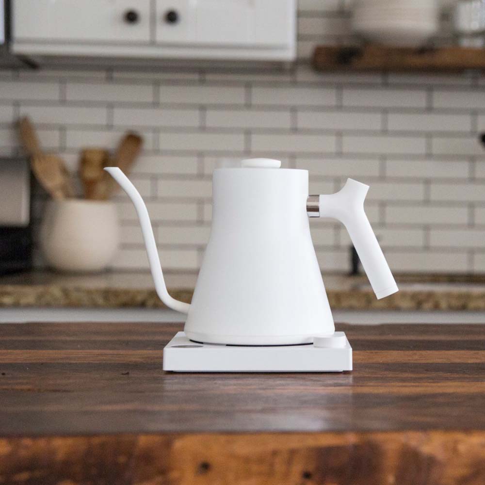 A white Fellow Stagg EKG Electric Kettle on the kitchen bench at home.