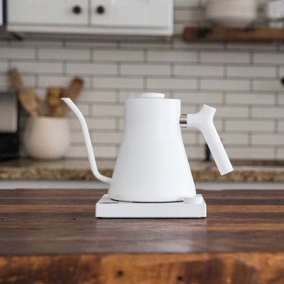 A white Fellow Stagg EKG Electric Kettle on the kitchen bench at home.