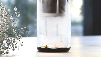 Hario "Drop" Water Dripper, Make delicious iced coffee using the natural dripping of water on a table with beautiful flower nearby at home.