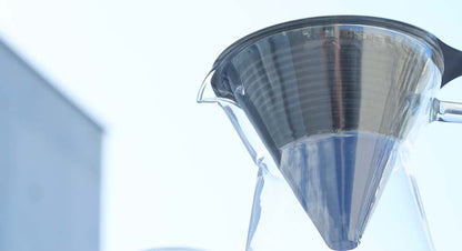 The Hario Metal Dripper with Decanter another angle shows the dripper is an all stainless steel cone dripper.