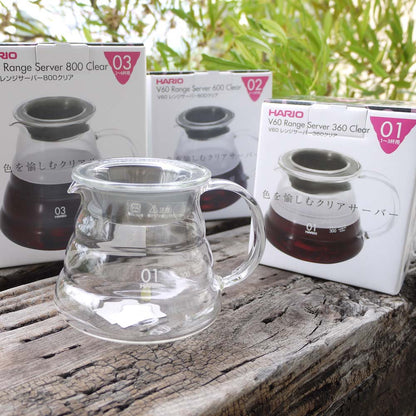 The Hario V60 Glass Server - Clear, beautifully beehive-shaped server and 3 boxes include 01 02 03 sizes sitting on the old natural timber.