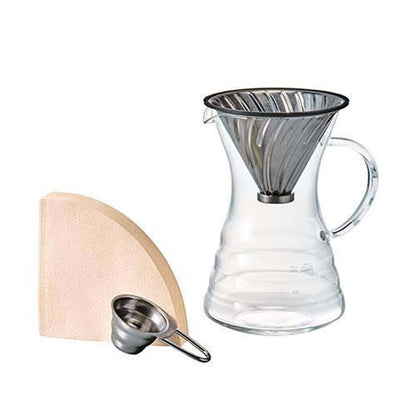 Hario V60 Pour Over Decanter set, includes a glass server, metal dripper, paper filters, and a metal spoon.